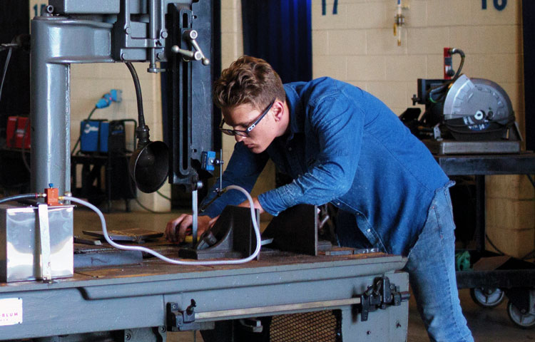 young man using saw